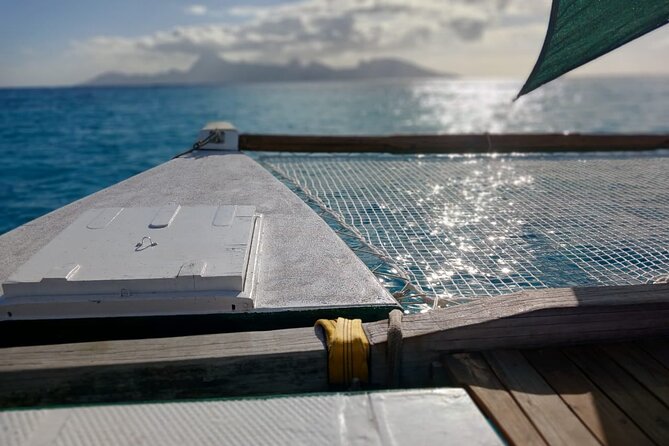 Sunset sailing trip on the Lagoon of Tahiti - A Polynesian canoe at sunset